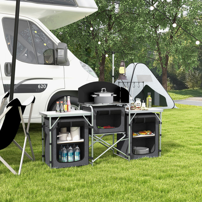 Outsunny Folding Camping Kitchen Table with Storage, Aluminum Portable Camping Table with 3 Fabric Cupboards, Windshield, Light Stand, Carrying Bag for BBQ, RV, Picnic, Black